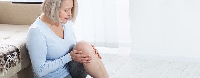 Woman suffering from knee pain