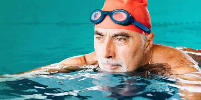 Man taking a swim in swimming pool