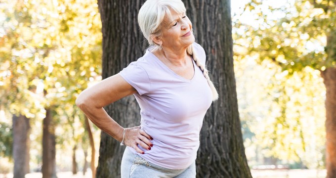 Senior woman exercises her hip