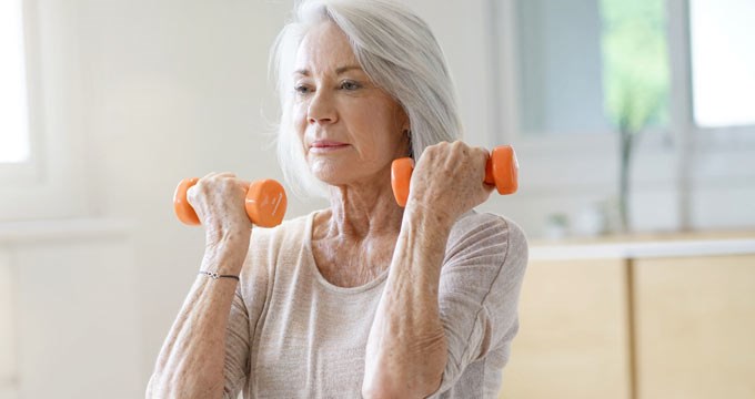 A woman exercising using weights