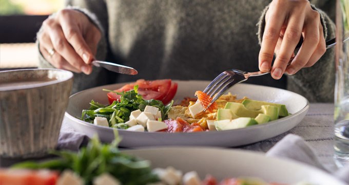 A woman enjoys a balanced meal